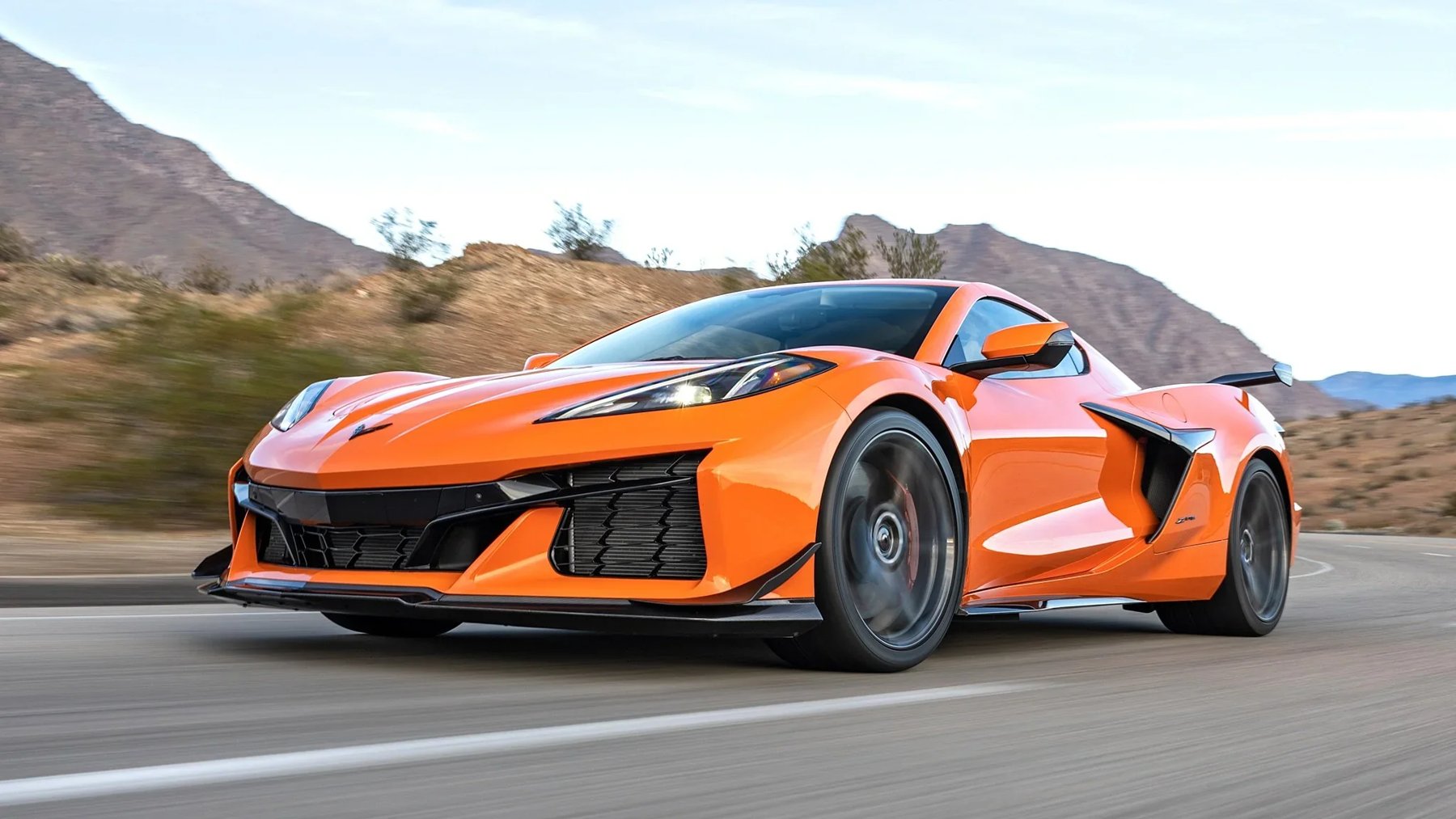 Orange C8 Corvette on a desert road