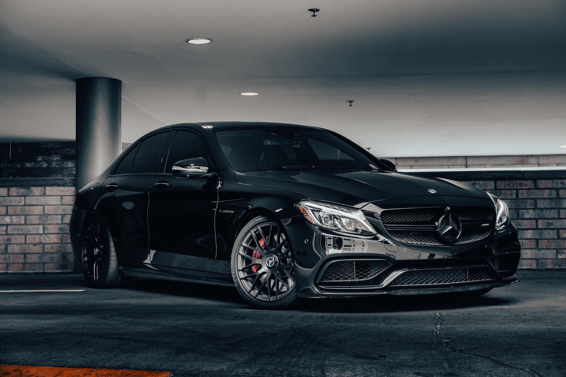 Black Mercedes-AMG sedan parked in a garage