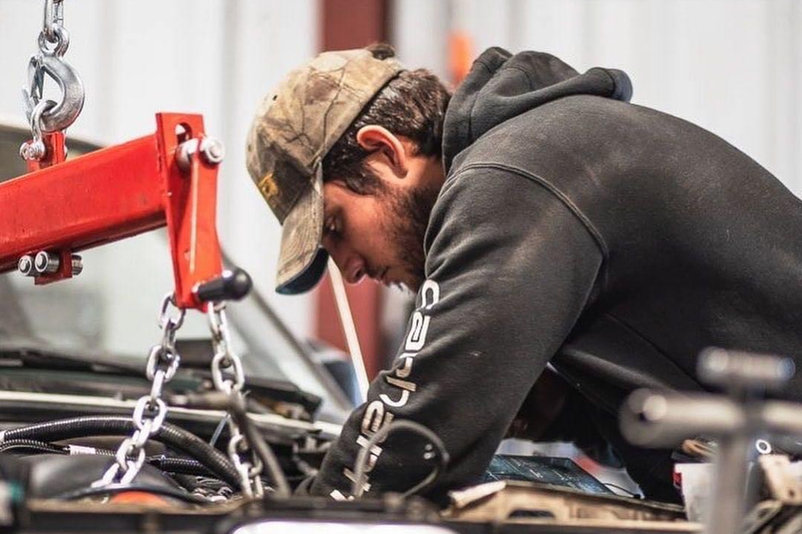 Garrett working over an engine bay